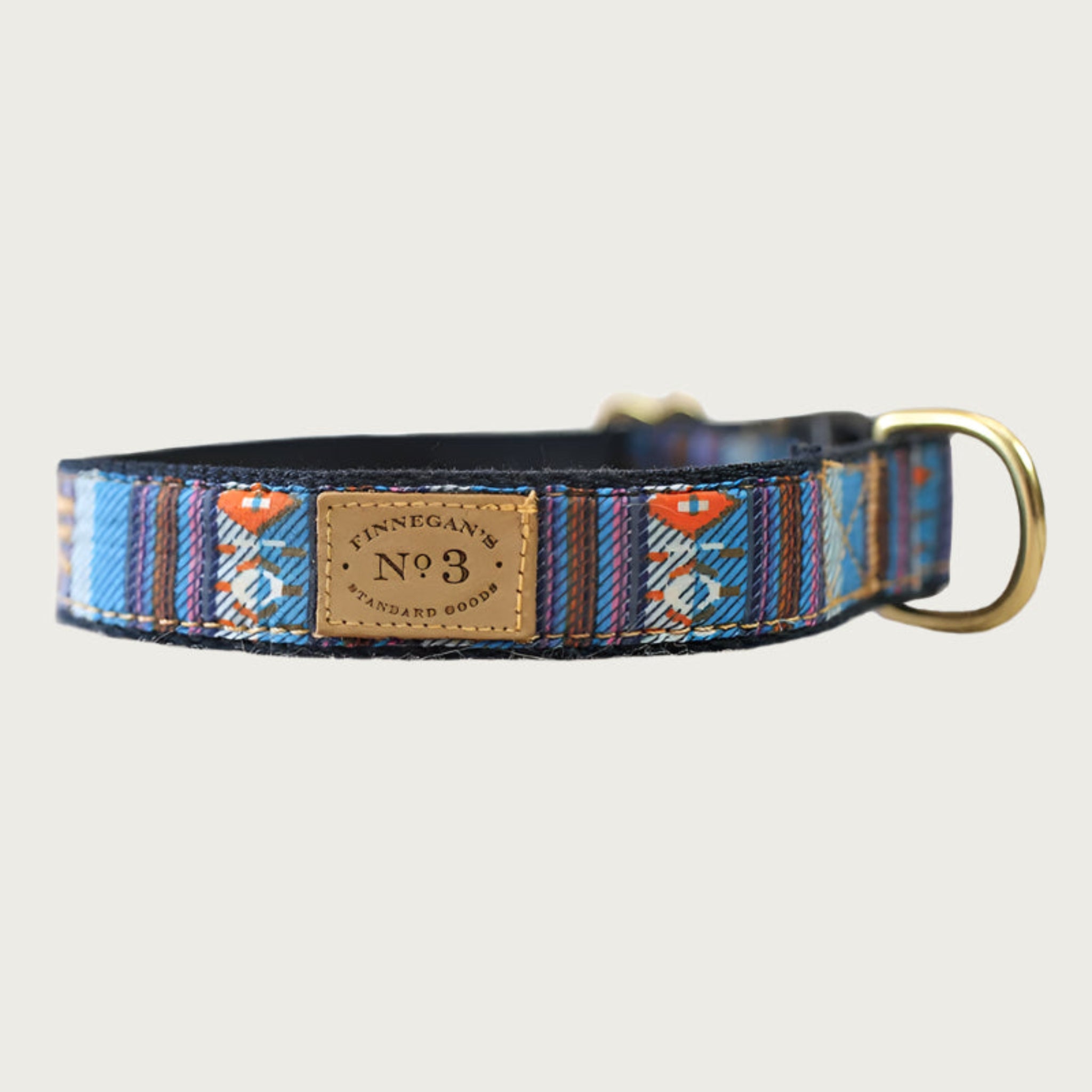 Dog collar with a serape blanket-inspired design, in rich shades of blue, brown and white with orange accents.