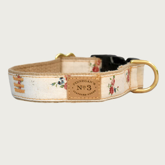 Dog collar with a cream base color, featuring sparse, scattered burgundy rose bouquets.
