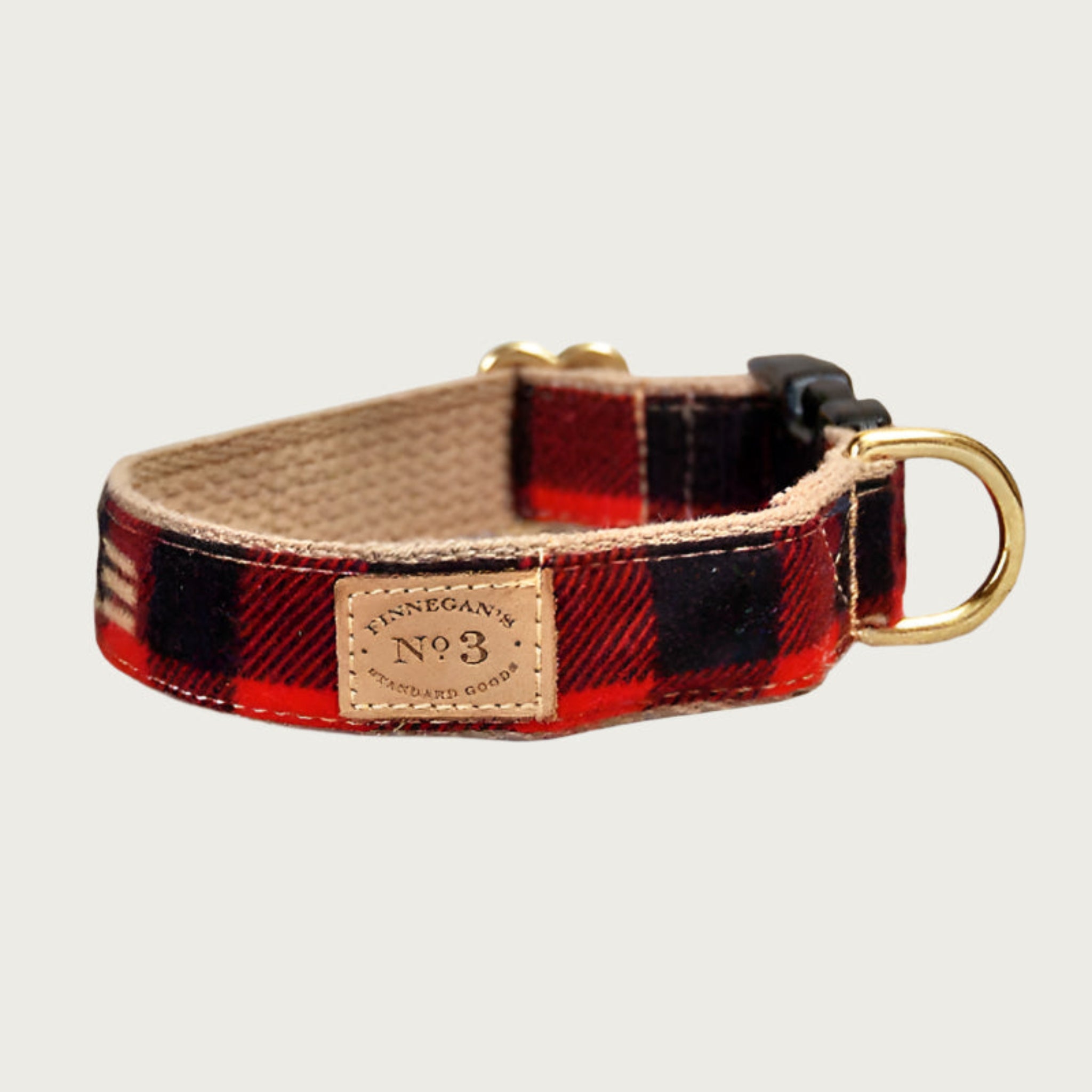 Red and black buffalo plaid dog collar with a black plastic buckle and brass D-ring.