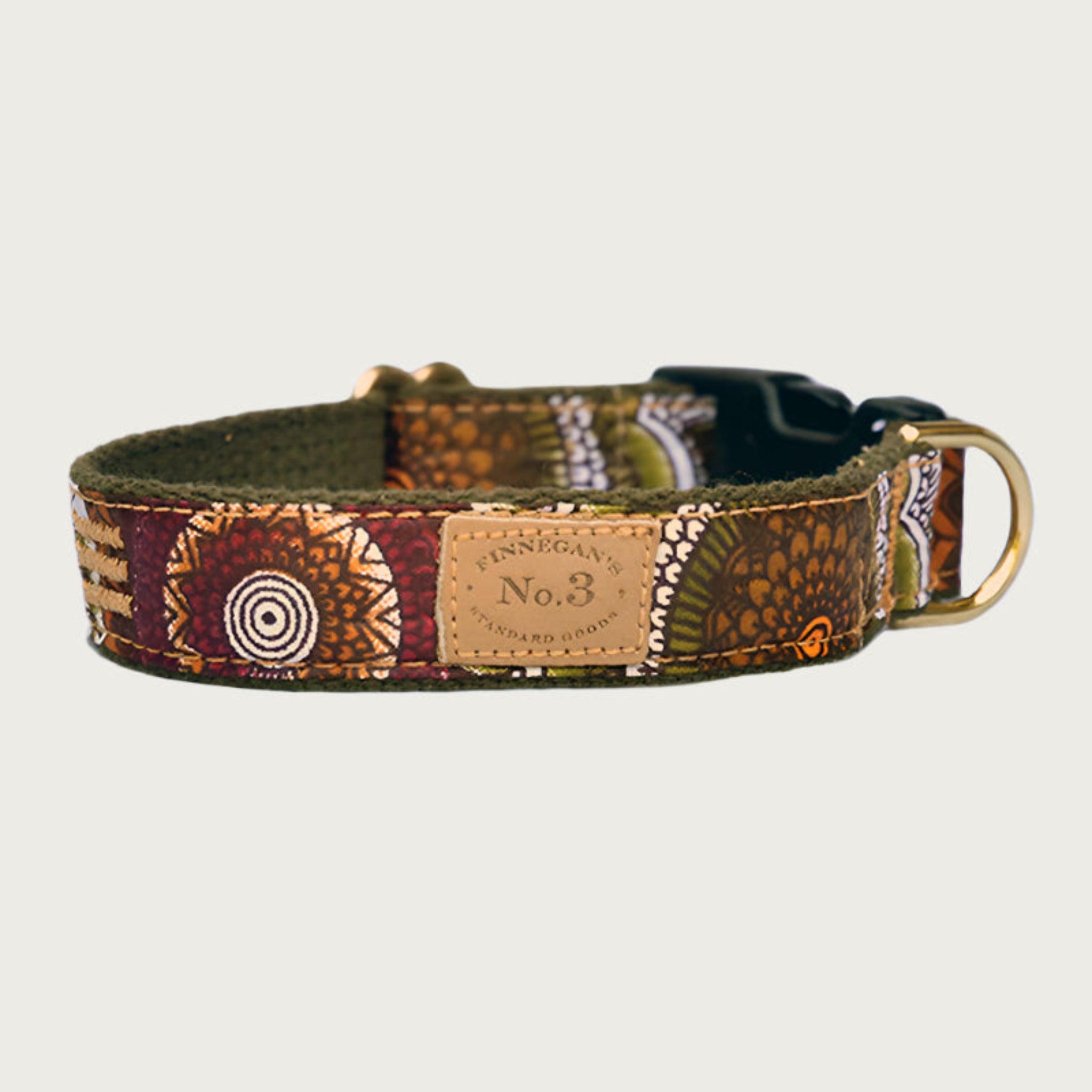 Dog collar with circular, geometric pattern in shades of olive green, burgundy, orange, brown and cream.