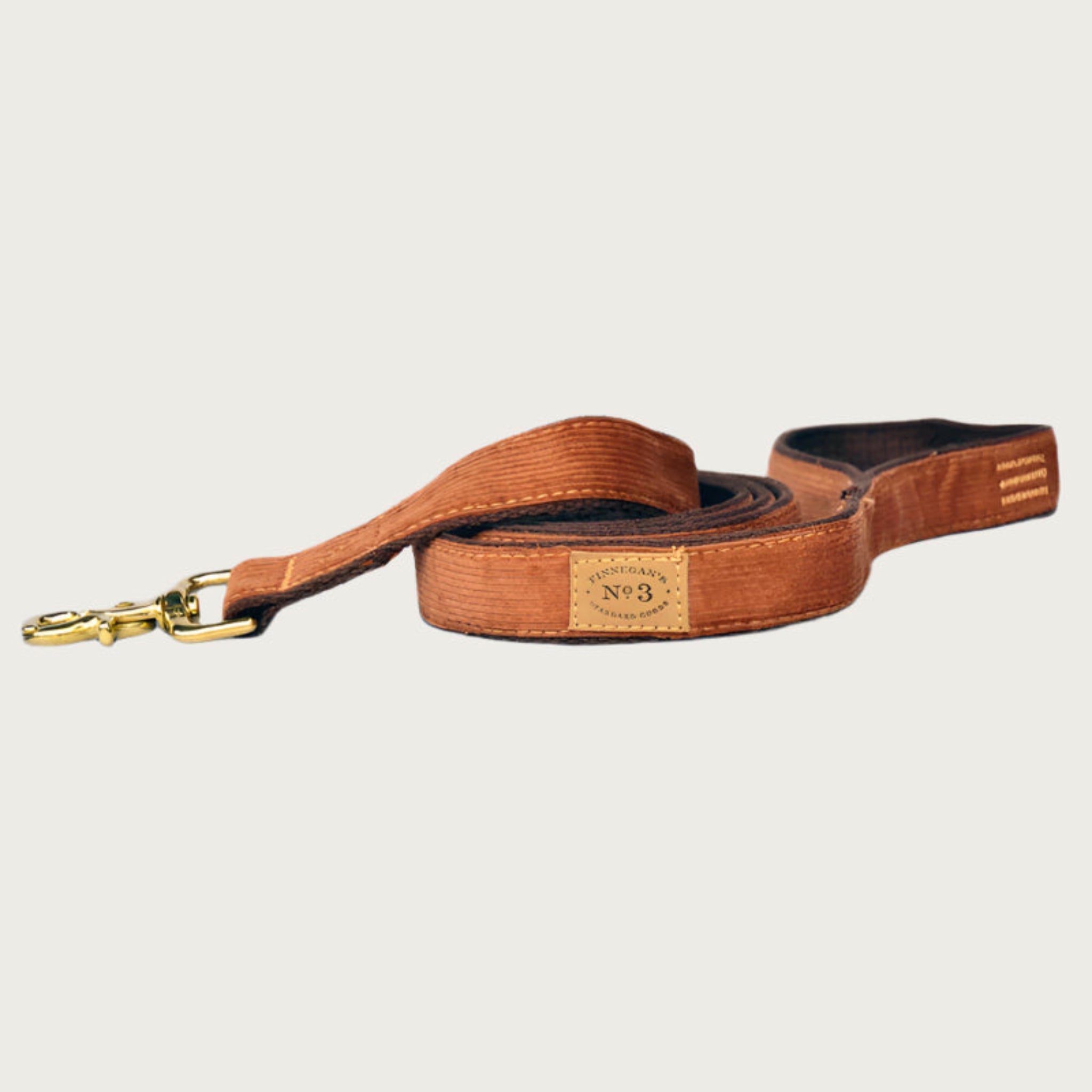 Caramel-brown corduroy dog leash with brass clasp.
