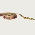 Load image into Gallery viewer, Dog leash with a tropical pattern in shades of maroon, peach, and brown.
