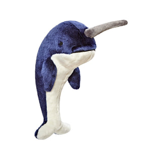 Plush Bleu Narwhal dog toy from Fluff & Tuff. Toy is curved (like it's in mid-leap) and is navy blue with a white belly, gray horn and black eyes.
