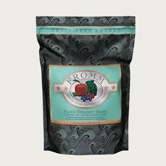 A 4 pound black and seafoam green bag of Fromm Salmon Tunachovy Recipe cat food. The banner on top of the bag reads "Grain-Free Entree".
