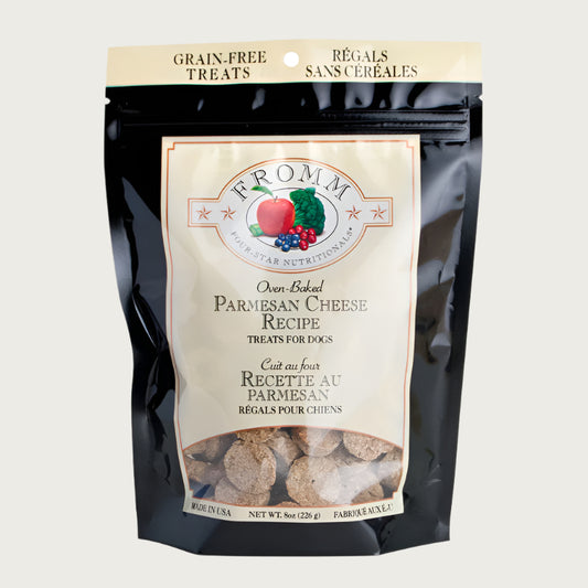 An 8 oz cream and black bag of Fromm Four-Star Nutritionals, Oven-Baked Parmesan Cheese Recipe dog treats. Banner on top of bag reads "grain-free treats".