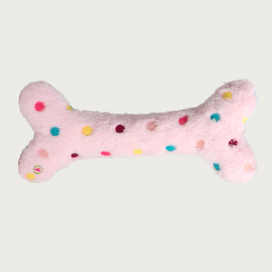 Reverse side of the Birthday Bone dog toy. It is covered in light pink plush with multicolored polka dots.