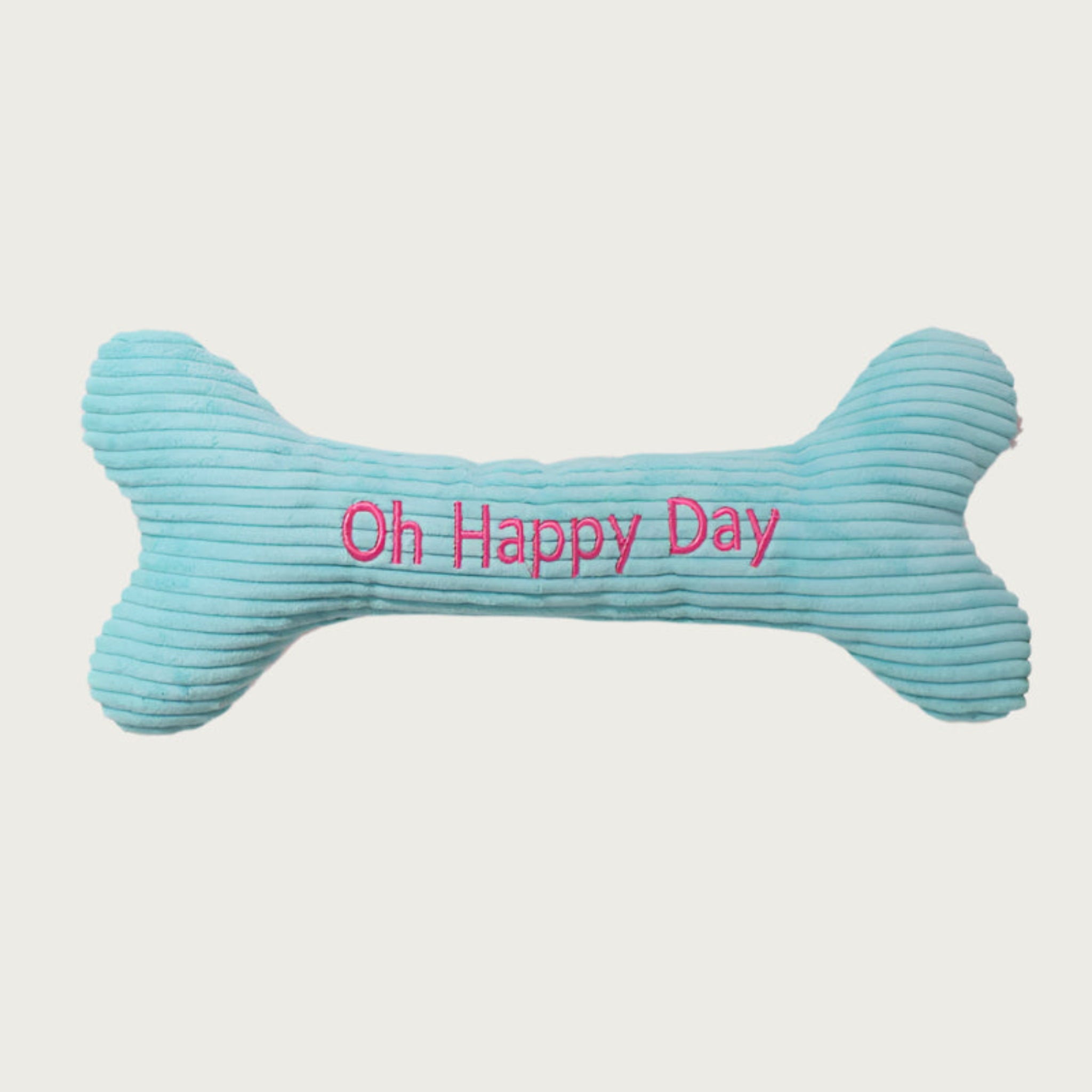 Light blue corduroy bone-shaped dog toy with 'Oh Happy Day' text in hot pink.