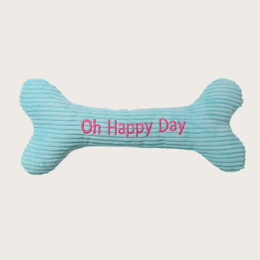Light blue corduroy bone-shaped dog toy with 'Oh Happy Day' text in hot pink.