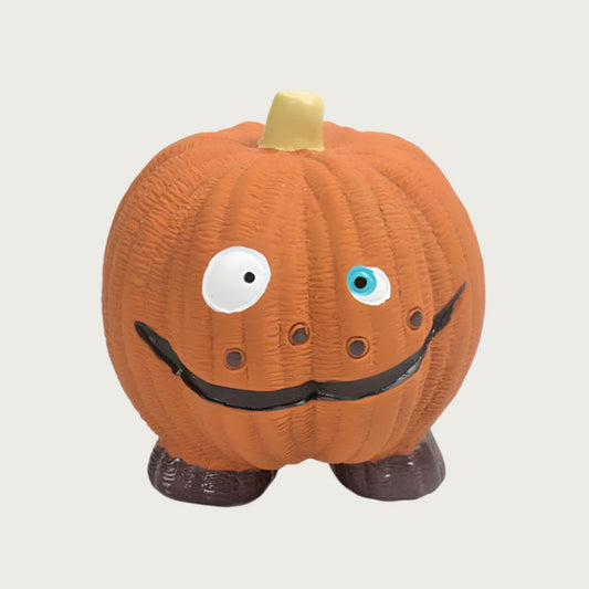 Pumpkin-shaped dog toy with brown feet and a funny facial grin.