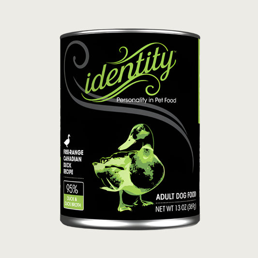 A 13 oz black can of Identity Adult Dog Food. Free-range Canadian Duck recipe, with 95% duck & duck broth. Illustration in center is a green duck.