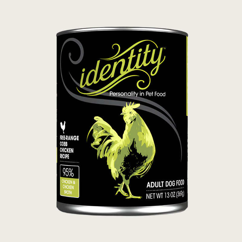 A 13 oz black can of Identity Adult Dog Food. Free-range Cobb Chicken recipe, with 95% chicken & chicken broth. Illustration in center is a green chicken.