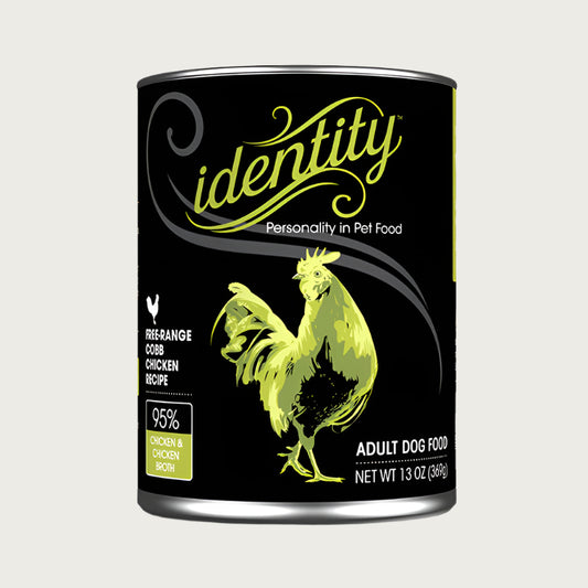 A 13 oz black can of Identity Adult Dog Food. Free-range Cobb Chicken recipe, with 95% chicken & chicken broth. Illustration in center is a green chicken.