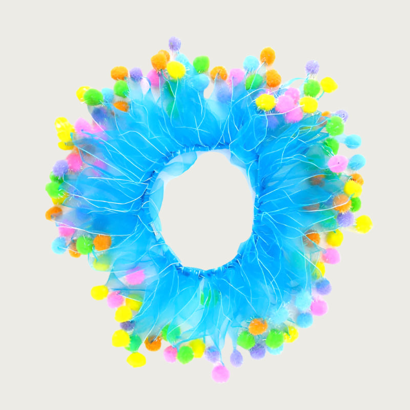 Decorative birthday themed dog collar, resembling a large hair scrunchie or clown collar. Its bright blue tulle ribbons are each topped off with a different color pom pom.
