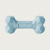 A light blue, heavy rubber dog bone toy with geometric texture.