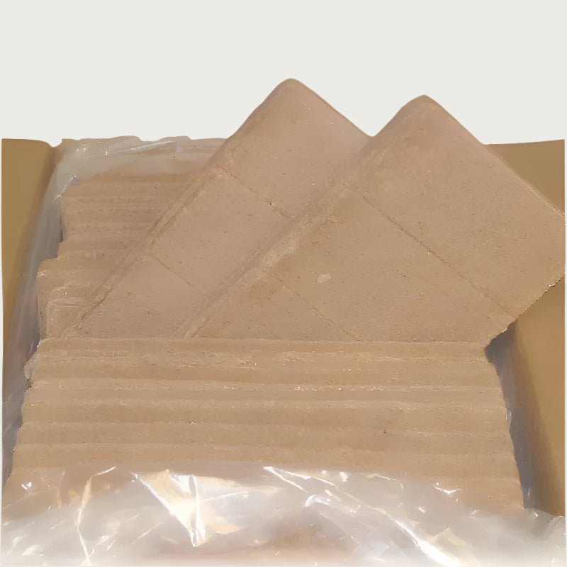 An open 25 pound box of Northwest Naturals raw diet for dogs, showing rectangular shaped bars of food packed side by side. Close up detail shows that each bar is scored into 4 sections; one section is equal to 1/4 pound of food.