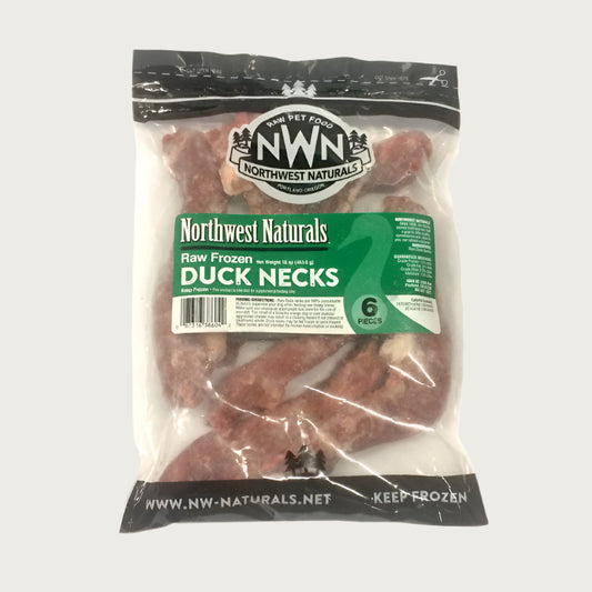 A bag of Northwest Naturals frozen raw duck necks for dogs, containing 6 necks. Bag is clear, and the raw duck necks are visible.