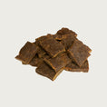 Load image into Gallery viewer, A close-up photo of a small handful of the Open Farm Beef dog treat. They are rectangular brown pieces that look like jerky, about 1"-2" long and 1/8" thick.
