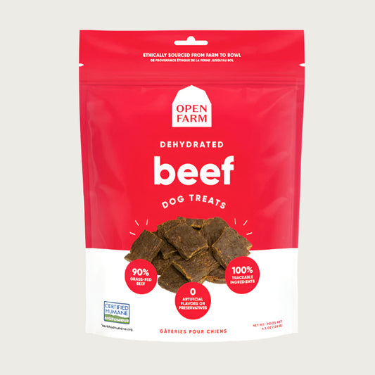A 4.5 oz red & white bag of Open Farm Dehydrated Beef Dog Treats. Small photo in center shows a close-up of a few of the jerky-style treats.