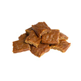 A close-up photo of a small handful of the Open Farm Chicken dog treat. They are rectangular brown pieces that look like jerky, about 1"-2" long and 1/8" thick.