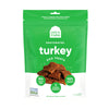 A 4.5 oz green & white bag of Open Farm Dehydrated Turkey Dog Treats. Small photo in center shows a close-up of a few of the jerky-style treats.