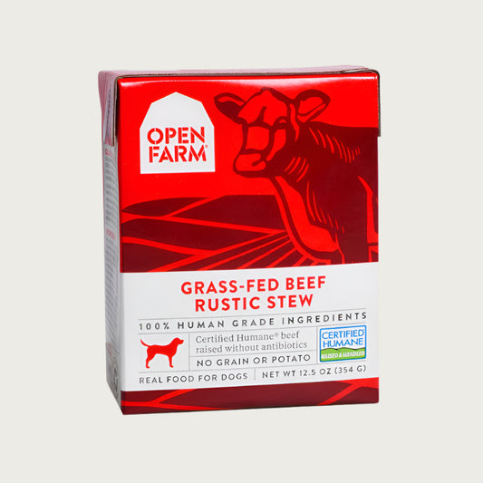 A 12.5 oz red and white carton of Open Farm Grass-Fed Beef Rustic Stew dog food. 100% Human Grade Ingredients. With Certified Humane beef, no grain or potato.