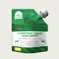 Load image into Gallery viewer, A 12 oz green & white pouch with spout, of Open Farm Homestead Turkey Bone Broth Meal Topper for Dogs & Cats. 

