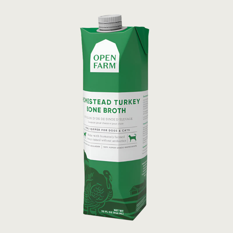 A 32 oz green & white carton with spout, of Open Farm Homestead Turkey Bone Broth Meal Topper for Dogs & Cats. 