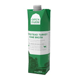 A 32 oz green & white carton with spout, of Open Farm Homestead Turkey Bone Broth Meal Topper for Dogs & Cats. 