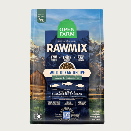 A bag of Open Farm RawMix Grain Free Wild Ocean Recipe dog food. Humanely raised and sustainably sourced. A mountain ranch scene is in the background of the bag, with a vertical blue bar behind the white text to highlight it.