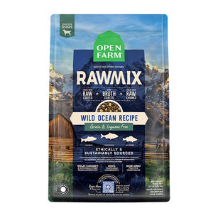 A bag of Open Farm RawMix Grain Free Wild Ocean Recipe dog food. Humanely raised and sustainably sourced. A mountain ranch scene is in the background of the bag, with a vertical blue bar behind the white text to highlight it.
