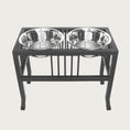 Load image into Gallery viewer, X-large elevated pet feeder with two metal bowls on a black stand.
