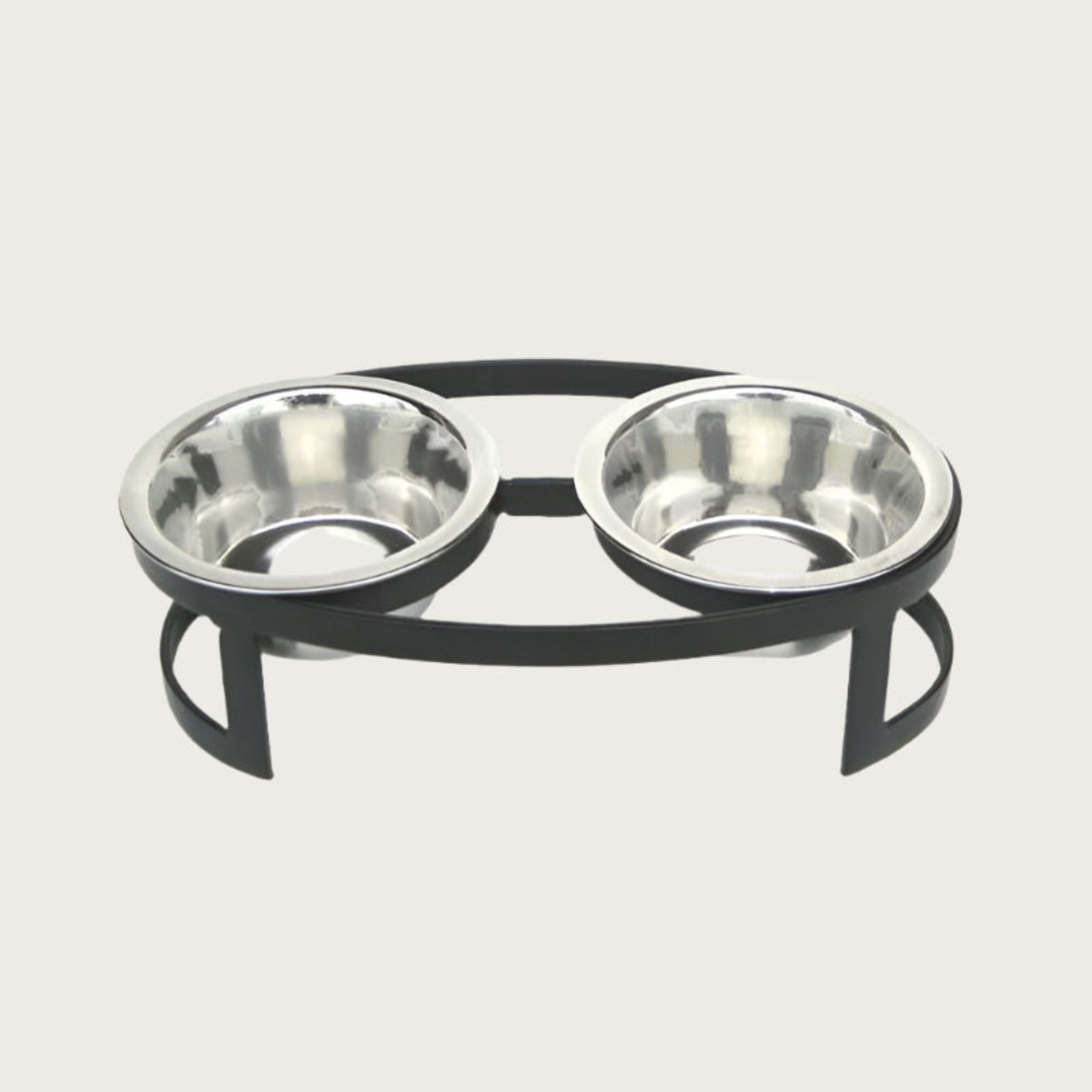 Small, oval shaped, elevated pet food bowl stand in black, with two stainless steel bowls.
