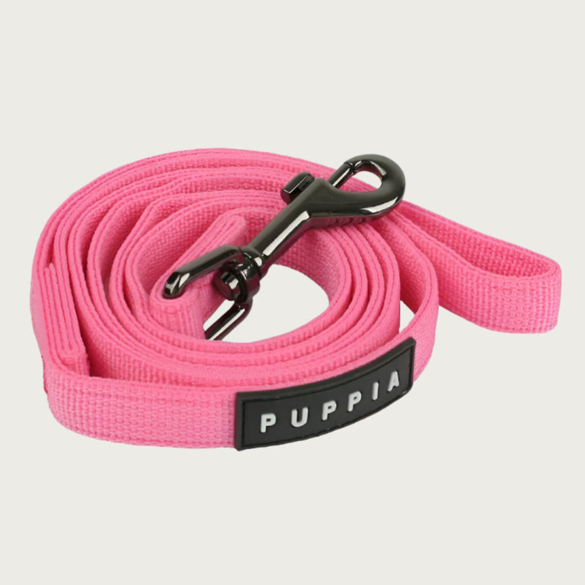 Bubblebum pink dog leash with dark metal clip and black & white Puppia tag.