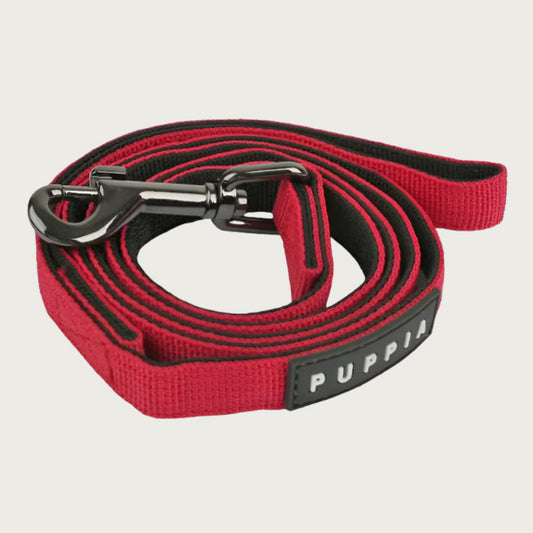 Red & black dog leash with dark metal clip and black & white Puppia tag.