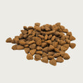 Load image into Gallery viewer, A close up photo of a handful of RAWZ cat dry kibble. They are small, brown, triangular shaped pieces.
