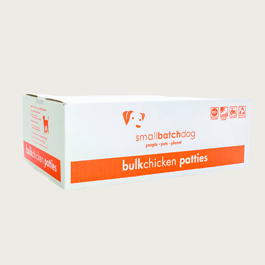 An orange and white box of Smallbatch chicken batch recipe, frozen raw dog food. This 18 pound bulk box contains 36 patties.