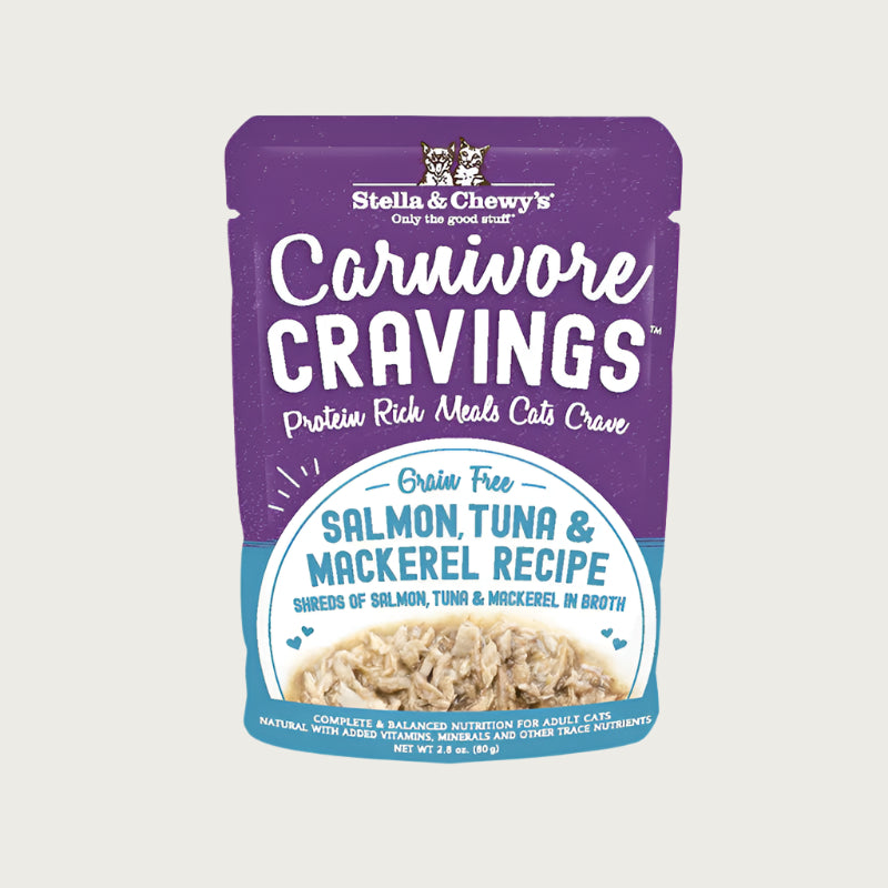 A 2.8 oz purple pouch of Stella & Chewy's Carnivore Cravings Savory Shreds, Salmon, Tuna & Mackerel Recipe in Tasty Broth for Cats. Small image on front shows shredded fish.