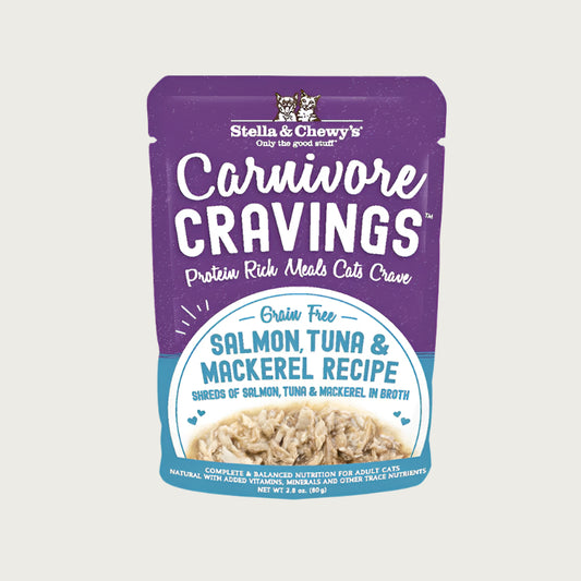 A 2.8 oz purple pouch of Stella & Chewy's Carnivore Cravings Savory Shreds, Salmon, Tuna & Mackerel Recipe in Tasty Broth for Cats. Small image on front shows shredded fish.