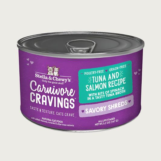 A 5.2 oz purple can of Stella & Chewy's Carnivore Cravings Savory Shreds, Tuna & Salmon Recipe, with bits of spinach in a tasty tuna broth for cats of all life stages.