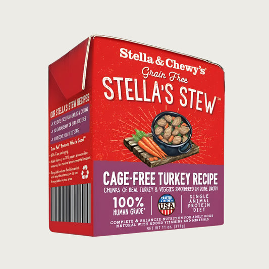 An 11 oz red & purple carton of Stella & Chewy's Grain Free Stella's Stew, Cage-Free Turkey Recipe for Dogs. Single animal protein diet, chunks of real turkey & veggies smothered in bone broth. 100% human grade. Corners of box fold up, to open carton from perforated top edge.