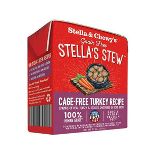An 11 oz red & purple carton of Stella & Chewy's Grain Free Stella's Stew, Cage-Free Turkey Recipe for Dogs. Single animal protein diet, chunks of real turkey & veggies smothered in bone broth. 100% human grade. Corners of box fold up, to open carton from perforated top edge.