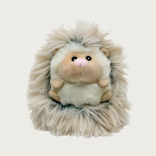 Front view of Fluffy Baby Hedgehog dog toy. It has a cream plush body with beige ears, feet and muzzle, with embroidered eyes and pink nose. Its back is covered in long, shaggy, cream & gray colored faux fur.
