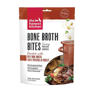 8 oz bag of Bone Broth Bites savory protein cookies from The Honest Kitchen; roasted with beef bone broth, sweet potatoes & parsley, dog treats. Small transparent window on front shows product inside: 1-2" wide brown squares.