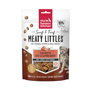 4 oz bag of Surf & Turf Meaty Littles from The Honest Kitchen, slow roasted beef & salmon recipe dog treats. 80% beef & salmon, just 2 calories per treat. Mini, tender & tasty rewards. Over 200 bites per bag. Human grade. Small transparent window on front shows product inside: small, reddish brown bites.