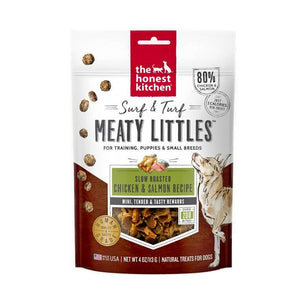 4 oz bag of Surf & Turf Meaty Littles from The Honest Kitchen, slow roasted chicken & salmon recipe dog treats. 80% chicken & salmon, just 2 calories per treat. Mini, tender & tasty rewards. Over 200 bites per bag. Human grade. Small transparent window on front shows product inside: small, reddish brown bites.