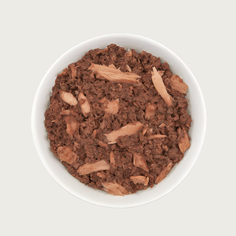 Close-up photo of a dish of Tiki Cat Ahi Tuna Recipe. Food is a reddish brown color, and is primarily a minced texture with flakes throughout.