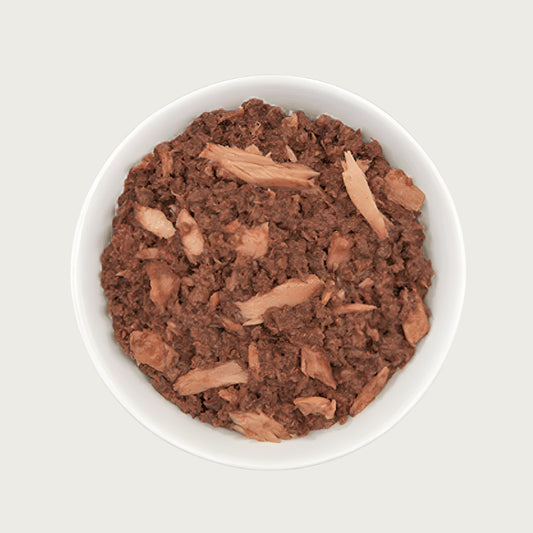 Close-up photo of a dish of Tiki Cat Ahi Tuna Recipe. Food is a reddish brown color, and is primarily a minced texture with flakes throughout.