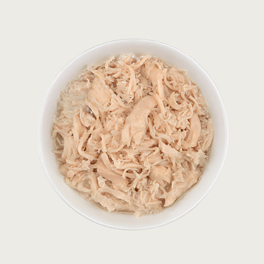 Close-up photo of a dish of Tiki Cat Succulent Chicken Recipe. Dish is full of shredded chicken.