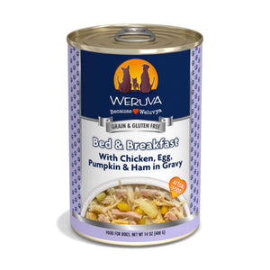 A 14 oz can with pull-top lid, of Weruva Bed & Breakfast wet food for dogs. Made with chicken, egg, pumpkin & ham in gravy. Image on can shows actual food, which is shreds of chicken, small pieces of ham, chunks of egg and pumpkin.