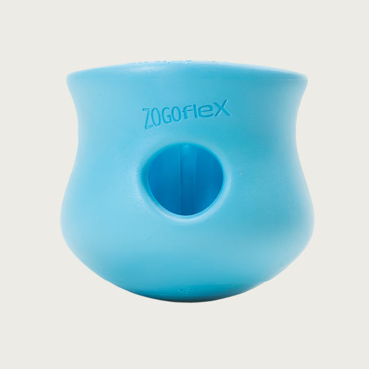 Aqua Blue colored Toppl toy. It has a cupped shape, with a slight indent on the top 1/3 of the toy, just under its lip. There is a round opening in the center, and the top of the toy is completely open. There are vertical ridges inside it.